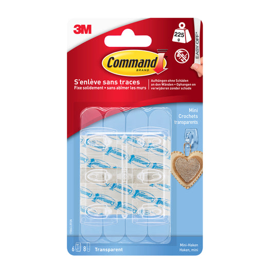 Eine Packung Command™ Mini-Haken, transparent, 17006CLR von 3M Deutschland GmbH enthält 6 transparente Haken und 8 transparente Strips. Die blau-rote Packung hat französische und englische Infos, perfekt für spurlos befestigen in Ihrem Raum.