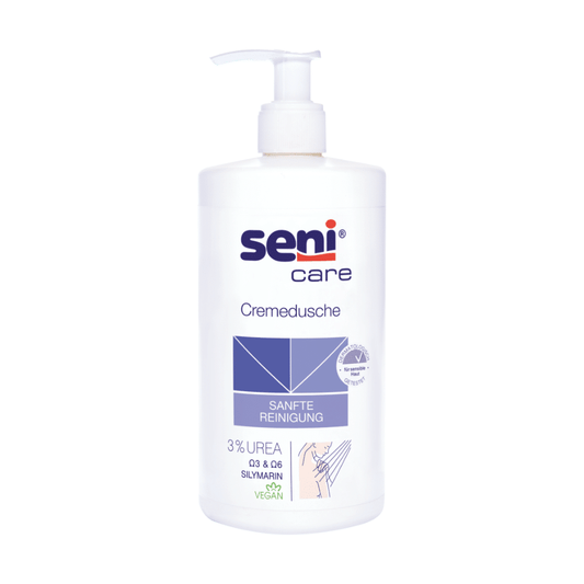 Die Seni Care Cremedusche von TZMO Deutschland GmbH, 500 ml, enthält 3% Urea, Silymarin und eine vegane Formel. Die weiße Flasche hat einen Pumpspender und trägt die blaue Grafik „SANFTE REINIGUNG“, ideal für trockene Haut.