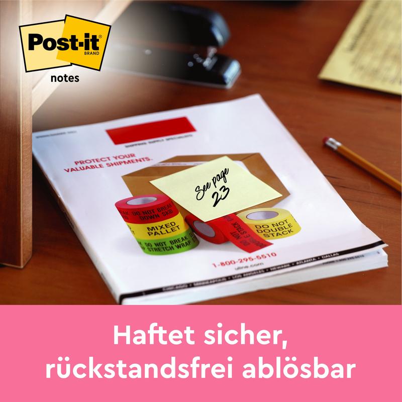 Žltý 3M Post-it® lístok (38 mm x 51 mm, žltá) s nápisom "Pozri stranu 23" je pripevnený na papieroch na stole. Vľavo hore je viditeľné logo Post-it, dole je nemecká informácia o lepiacich poznámkach, 100 listov/blok.