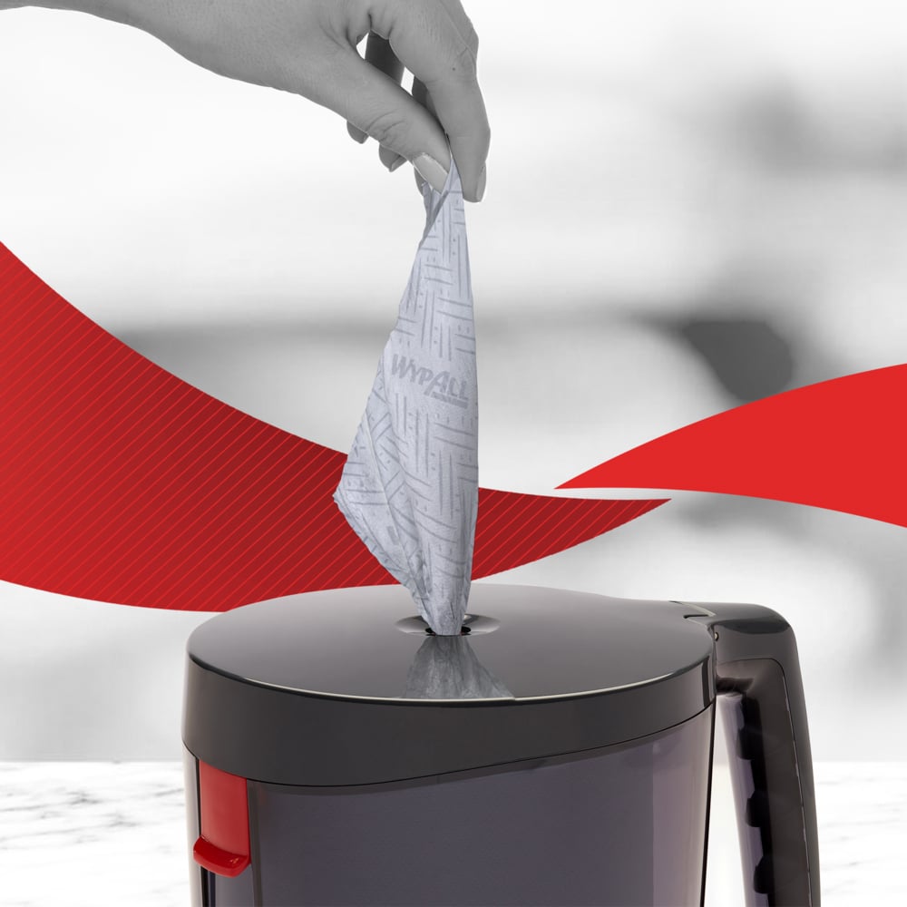 Ruka ťahá WypAll® Reach™ papierovú utierku na potraviny a hygienu - centrálny odber od Kimberly-Clark GmbH z šedej nádoby, ktorá podporuje hygienu. V pozadí sú viditeľné červené, zakrivené línie.