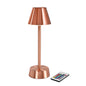 Bezdrôtová LED lampa ZELDA v ružovozlatej farbe od Duni GmbH má kužeľovitý tienidlo, valcovitý podstavec a dodáva sa s malým diaľkovým ovládačom s farebnými tlačidlami.
