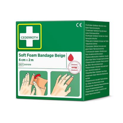 Zelená škatuľa s Cederroth mäkkou penovou bandážou béžovou 6 cm x 2m (1 kus) od Orkla Wound Care AB, s obrázkami aplikácie, bielym krížovým logom, informáciami o produkte a viacjazyčným textom.