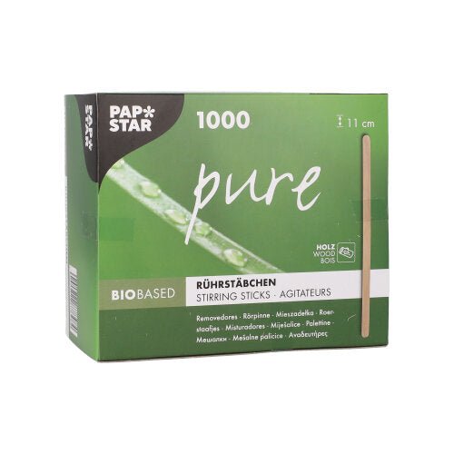 Zeleno-biela škatuľa od PAPSTAR GmbH s nápisom "pure" obsahuje 1000 ekologických, stabilných drevených miešacích paličiek (11 cm). Skladacia škatuľa zobrazuje informácie o produkte v niekoľkých jazykoch a vertikálny obrázok paličky.