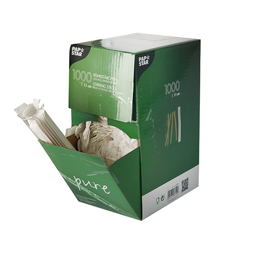Zeleno-biela škatuľa od PAPSTAR GmbH s nápisom „1000 miešacích paličiek, drevo ‚pure‘, jednotlivo zabalené“ ukazuje niekoľko drevených miešacích paličiek, ktoré vyčnievajú z otvorenej prednej strany.