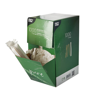 Zeleno-biela škatuľa od PAPSTAR GmbH s nápisom „1000 miešacích paličiek, drevo ‚pure‘, jednotlivo zabalené“ ukazuje niekoľko drevených miešacích paličiek, ktoré vyčnievajú z otvorenej prednej strany.