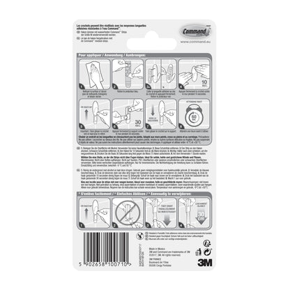 Die Rückseite einer Command™ Bad Handtuchhaken-Verpackung der 3M Deutschland GmbH enthält eine bebilderte und schriftliche Schritt-für-Schritt-Anleitung in mehreren Sprachen zum Anbringen und Entfernen der Streifen sowie einen Barcode und das 3M-Logo am unteren Rand.