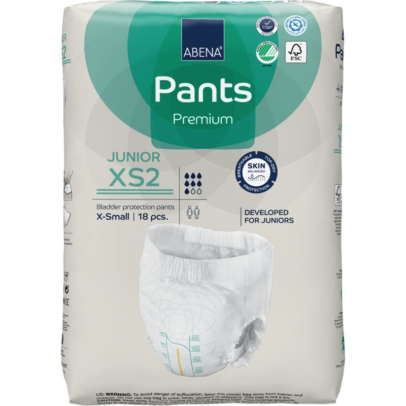 Balenie ABENA Pants Junior Premium, veľkosť XS2 (18 kusov) od spoločnosti Abena Re-Seller GmbH poskytuje ochranu pre juniorov. Obal zobrazuje vlastnosti produktu, certifikačné logá a obrázok plienky.