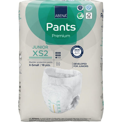 Balenie ABENA Pants Junior Premium, veľkosť XS2 (18 kusov) od spoločnosti Abena Re-Seller GmbH poskytuje ochranu pre juniorov. Obal zobrazuje vlastnosti produktu, certifikačné logá a obrázok plienky.