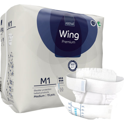 Eine Packung Abena Re-Seller GmbH ABENA Wing Premium ist mit einem ausgeklappten Pad vorne abgebildet, das Schutz und Komfort bietet. Auf der Verpackung steht, dass sie 15 mittelgroße Pads zum Schutz der Blase enthält.