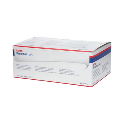 Vystavená je krabica BSN Elastomull® haft, biela elastická gáza od BSN Medical GmbH. Balenie má modré a červené akcenty, ktoré zvýrazňujú etiketu ako elastickú fixačnú bandáž. Text na krabici obsahuje informácie o produkte a špecifikácie vo viacerých jazykoch.