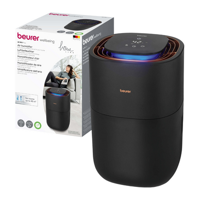 Na obale je zobrazený čierny Beurer LB 300 zvlhčovač vzduchu od spoločnosti Beurer GmbH s digitálnym ovládacím panelom na vrchu. Obal zobrazuje značku a obrázok relaxujúcej ženy, čo naznačuje, že produkt je určený na domáce použitie. Viacjazyčný text zdôrazňuje výhody produktu pre hygienický vzduch v miestnosti.