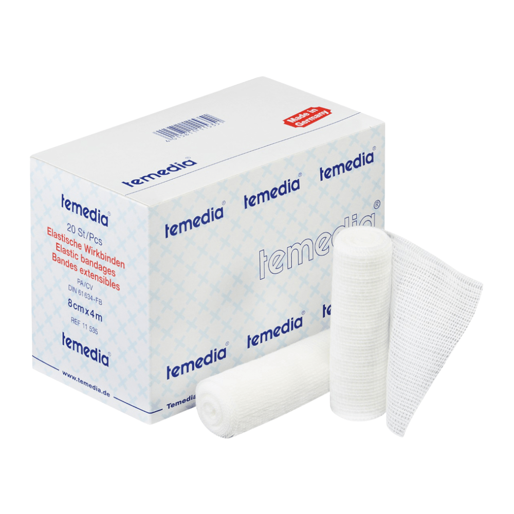 Krabica Holthaus Temedia® Wirkbinde, 10 cm x 4 m | Balenie (20 kusov) od Holthaus Medical GmbH & Co. KG je vystavené, pričom názov produktu a detaily sú viditeľné na obale. Vedľa sa nachádzajú dve zrolované elastické obväzy a jeden rozvinutý kus gázy. Obal je navrhnutý v modro-bielej farbe s červeným textom, ktorý uvádza špecifikácie zdravotníckeho produktu.
