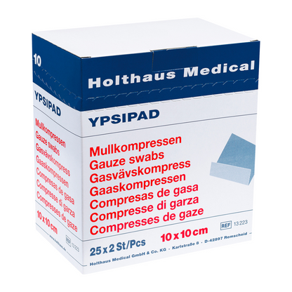 V modro-bielej škatuli Holthaus YPSIPAD gázová kompresia od Holthaus Medical GmbH & Co. KG sa nachádza 25 balení, z ktorých každé obsahuje 2 sterilné gázové tampóny, ktoré majú rozmer 10 cm x 10 cm. Text na škatuli zdôrazňuje ich dobrú savosť a je vytlačený vo viacerých jazykoch.