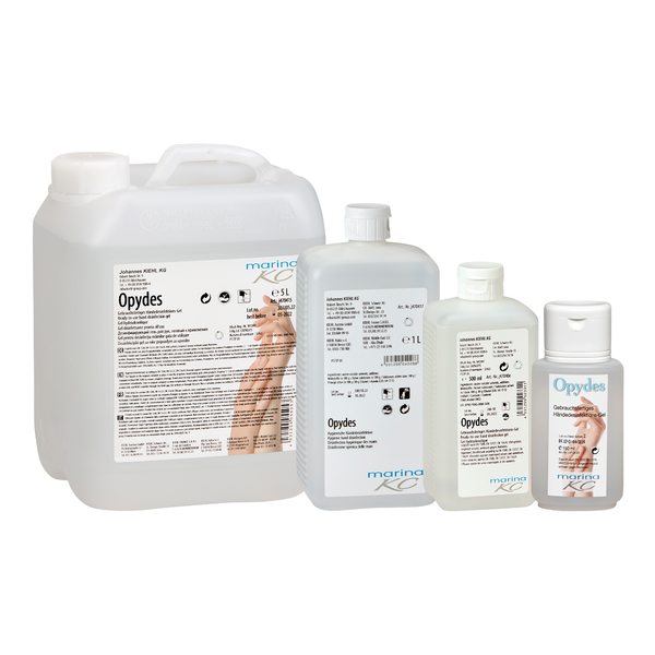 Zobrazené sú štyri priehľadné fľaše Kiehl Opydes Hygienická dezinfekcia rúk od Johannes Kiehl KG v rôznych veľkostiach v rade. Nesú biele a modré písmo s ručnými symbolmi na hygienickú dezinfekciu rúk a zníženie zárodkov.