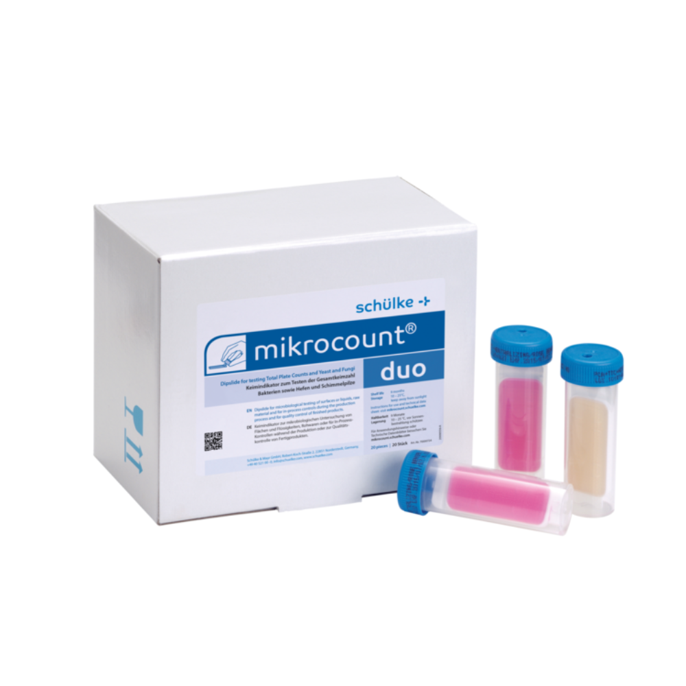 Obrázok zobrazuje škatuľu s nápisom „Schülke mikrocount® duo, indikátor mikroorganizmov | Balenie (20 kusov)“ od značky „Schülke & Mayr GmbH“ vedľa troch farebne označených skúmaviek s modrými uzávermi. Skúmavky obsahujú ružové a béžové látky, ktoré sa používajú na detekciu mikroorganizmov na povrchoch a v kvapalinách, vrátane kvasiniek a plesní.